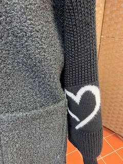 Black long line fleece with knitted sleeves with heart motifs