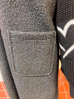 Black long line fleece with knitted sleeves with heart motifs
